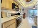 The kitchen features wood cabinets, smooth countertops, an eat-in area, and sleek, stainless-steel appliances at 8174 Terrace Garden N Dr # 307, St Petersburg, FL 33709