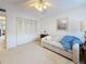 Living room featuring neutral carpet, ceiling fan, sofa and closet at 8174 Terrace Garden N Dr # 307, St Petersburg, FL 33709