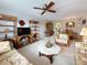 A cozy living room has neutral carpet and ceiling fan, with a view of the adjacent dining area and comfortable furnishings at 8174 Terrace Garden N Dr # 307, St Petersburg, FL 33709
