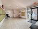An indoor entryway with tiled floors leads to unit doors and a glass door, showcasing a bright and welcoming building lobby at 8174 Terrace Garden N Dr # 307, St Petersburg, FL 33709