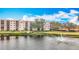 Scenic view of a pond with a fountain in front of a multi-story residential building on a sunny day at 8174 Terrace Garden N Dr # 307, St Petersburg, FL 33709
