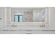 Modern bathroom featuring double sinks, marble countertops, and an illuminated mirror at 902 W Fribley St, Tampa, FL 33603