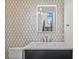 Modern bathroom featuring unique patterned tiles, a vessel sink, a stylish vanity, and modern lighting at 902 W Fribley St, Tampa, FL 33603
