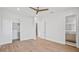 Bright bedroom with hardwood floors, ceiling fan, and access to the ensuite bathroom at 902 W Fribley St, Tampa, FL 33603