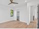 Spacious bedroom boasts hardwood floors, a ceiling fan, and a walk-in closet for optimal storage at 902 W Fribley St, Tampa, FL 33603