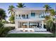 Stunning two-story modern home with balcony, patio, and lush tropical landscaping at 902 W Fribley St, Tampa, FL 33603