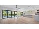 Spacious living room flowing into a modern kitchen with a large island and sliding glass doors that lead to a pool at 902 W Fribley St, Tampa, FL 33603