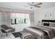 Charming bedroom with plush bedding, stylish decor, and a relaxing seating area at 9705 Bay Grove Ln, Tampa, FL 33615