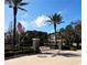 Gated community entrance with stone pillars, mature trees, and a well-manicured landscape at 9705 Bay Grove Ln, Tampa, FL 33615