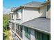 The exterior side of a house with screened in patios and neutral siding is on display at 9705 Bay Grove Ln, Tampa, FL 33615