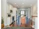 Modern kitchen has stainless appliances, white cabinets, wood floors, and an island with a sink at 9705 Bay Grove Ln, Tampa, FL 33615