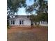 The backyard includes a wooden deck area for outdoor enjoyment and overlooks a nice yard with mature trees at 1001 W Baker St, Plant City, FL 33563