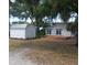 Backyard with a shed, wooden deck, and mature trees at 1001 W Baker St, Plant City, FL 33563