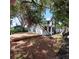 Backyard featuring a wooden deck, mature trees, and ample green space at 1001 W Baker St, Plant City, FL 33563
