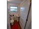 Bathroom featuring a pedestal sink, toilet, and neutral decor at 1001 W Baker St, Plant City, FL 33563