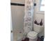 Cozy bathroom featuring tiled shower with patterned curtain and decorative accents at 1001 W Baker St, Plant City, FL 33563