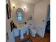 Bathroom featuring a pedestal sink, framed art, and a window for natural light at 1001 W Baker St, Plant City, FL 33563