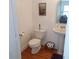 Classic bathroom with pedestal sink, hardwood floors, and toilet at 1001 W Baker St, Plant City, FL 33563