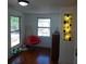 Bedroom featuring an accent chair, hardwood floors, and two windows at 1001 W Baker St, Plant City, FL 33563