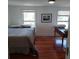 Bedroom featuring hardwood floors and two windows that provide ample natural light at 1001 W Baker St, Plant City, FL 33563