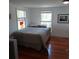 Cozy bedroom featuring hardwood floors and two windows that provide ample natural light at 1001 W Baker St, Plant City, FL 33563