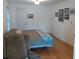 Bedroom with hardwood floors, a bed, and lots of wall decor at 1001 W Baker St, Plant City, FL 33563