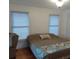 Bright bedroom featuring large windows, hardwood floors, a ceiling light, and soft decor at 1001 W Baker St, Plant City, FL 33563