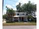 Inviting two-story home featuring a charming front porch, lush landscaping, and a classic architectural style at 1001 W Baker St, Plant City, FL 33563