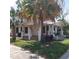 Charming two-story home with a covered porch, mature landscaping, and a healthy palm tree at 1001 W Baker St, Plant City, FL 33563