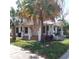 Inviting two-story home with a classic porch, a well-manicured lawn, and classic architectural style at 1001 W Baker St, Plant City, FL 33563