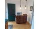 Kitchen with wooden cabinets, island, pendant lighting, and green paneled door at 1001 W Baker St, Plant City, FL 33563