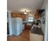 Cozy kitchen with wooden cabinets, white appliances, a farmhouse sink, and butcher block countertops at 1001 W Baker St, Plant City, FL 33563