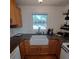 Kitchen with a farmhouse sink, wood cabinets, and granite countertops at 1001 W Baker St, Plant City, FL 33563