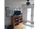 Bright room with hardwood floors, shelving, ceiling fan, and glass doors to outside at 1001 W Baker St, Plant City, FL 33563