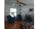 Bright and airy living room featuring a classic ceiling fan, hardwood floors, and ample natural light at 1001 W Baker St, Plant City, FL 33563