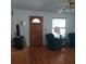 A classic living room featuring hardwood floors, a decorative front door and lots of natural light at 1001 W Baker St, Plant City, FL 33563