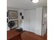 Office space with a wooden desk and ample wall space with multiple frames and a closet at 1001 W Baker St, Plant City, FL 33563