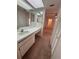 Vanity area with mirrors leading to carpeted bedroom area with closet access at 106 Lakeside Ct, Oldsmar, FL 34677