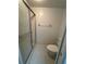 Bathroom featuring a walk-in shower with glass doors and tiled flooring at 106 Lakeside Ct, Oldsmar, FL 34677