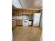 Functional kitchen featuring wood cabinetry, essential appliances and tile flooring at 106 Lakeside Ct, Oldsmar, FL 34677