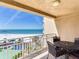 Charming balcony with a cozy table offers panoramic views of the ocean and beach at 11 San Marco St # 807, Clearwater Beach, FL 33767
