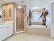 This primary bathroom offers a large soaking tub and glass enclosed shower at 11 San Marco St # 807, Clearwater Beach, FL 33767