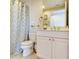 Bright bathroom with a modern vanity, toilet, and patterned shower curtain at 11 San Marco St # 807, Clearwater Beach, FL 33767