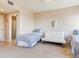 Cozy bedroom featuring two twin beds, a comfortable sofa, and neutral decor at 11 San Marco St # 807, Clearwater Beach, FL 33767