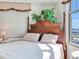 This Primary bedroom features a four poster bed, soft light, and large windows at 11 San Marco St # 807, Clearwater Beach, FL 33767