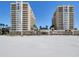 Stunning exterior view of beachfront condos with balconies and white sandy beach at 11 San Marco St # 807, Clearwater Beach, FL 33767