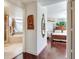 Hallway featuring elegant hardwood floors leading to a spacious bedroom and bathroom at 11 San Marco St # 807, Clearwater Beach, FL 33767