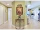 Hallway with hardwood floors leading to kitchen and other rooms at 11 San Marco St # 807, Clearwater Beach, FL 33767