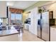 Well-lit kitchen area with stainless steel refrigerator, white cabinetry, and a breakfast nook overlooking the city at 11 San Marco St # 807, Clearwater Beach, FL 33767