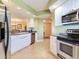 Modern kitchen with stainless steel appliances, white cabinetry, and light wood flooring at 11 San Marco St # 807, Clearwater Beach, FL 33767
